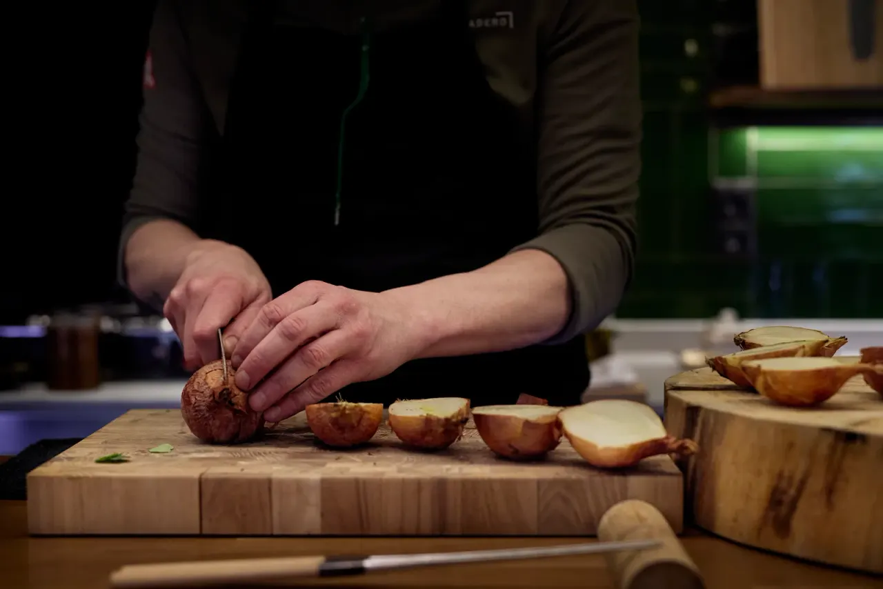 Roasted onions opened and lined up on the board, ready for the pass